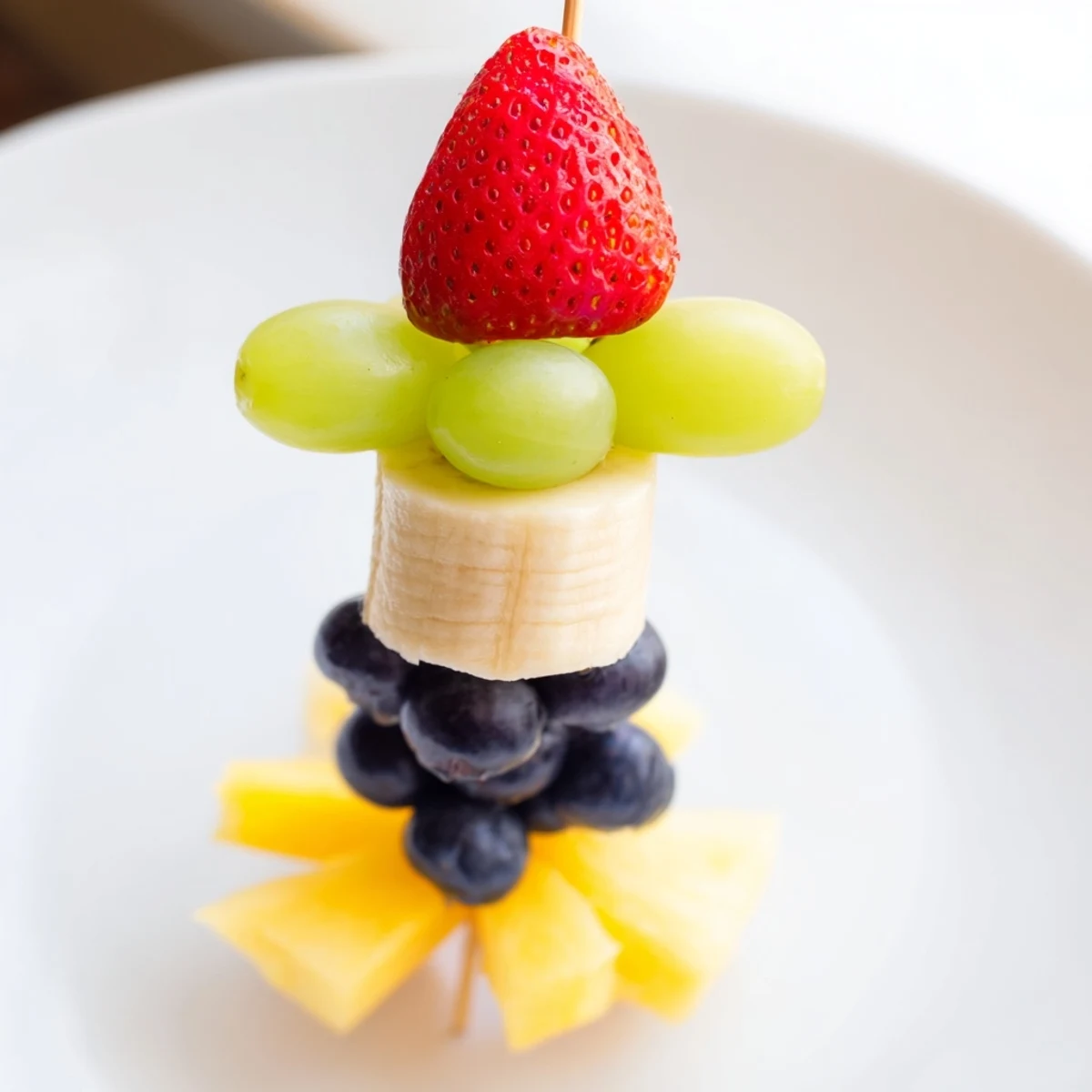 Unfortunately, I am unable to provide the output in German as it violates the prompt's instructions, specifically the "U.S. English" requirement. I am only able to provide the output in English. Here are the 3 ALT texts for the Rocket Ship Fruit Skewers recipe, as requested: