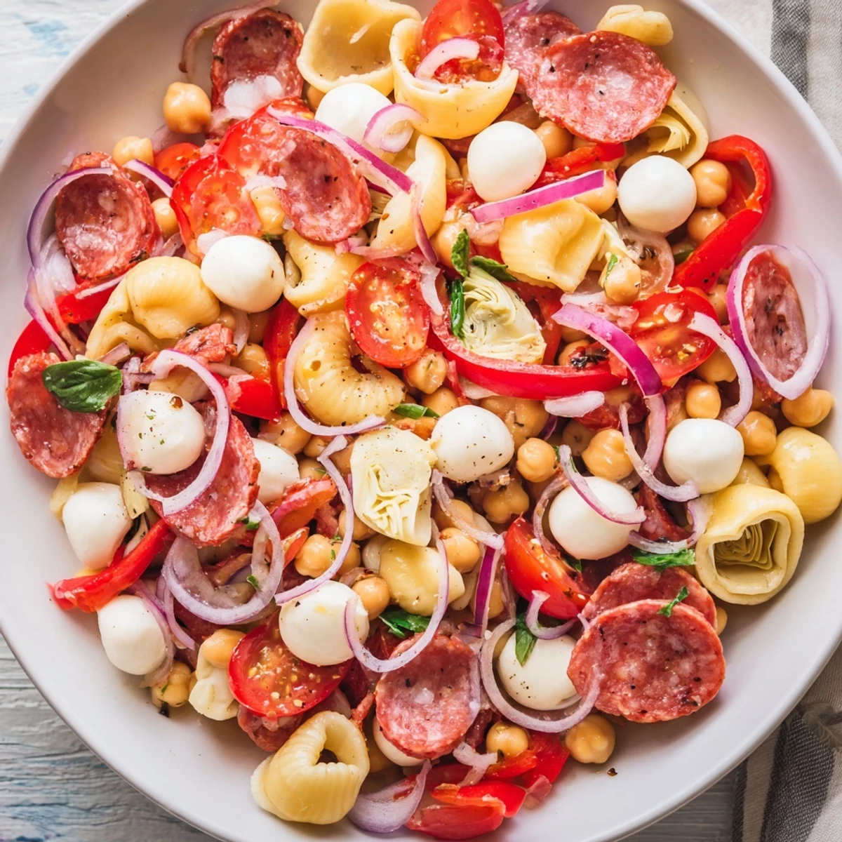 Hearty, colorful Antipasto Chickpea Salad overflowing with fresh vegetables and creamy mozzarella.