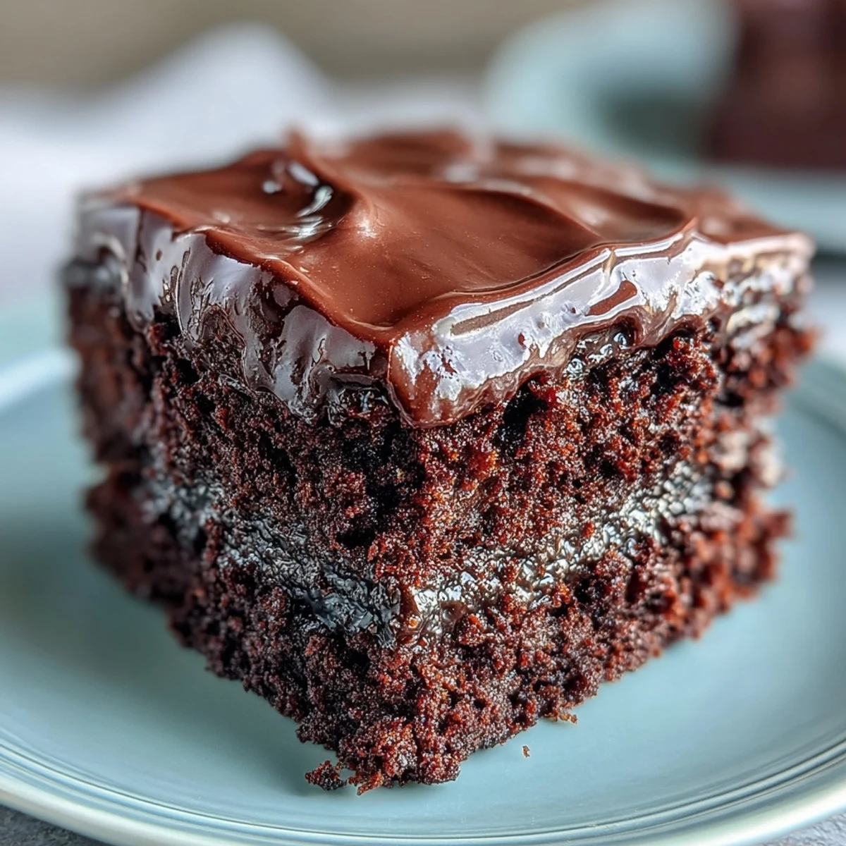 Moist and rich Easy Chocolate Fudge Cake with a glossy chocolate glaze, perfect for celebrations or an indulgent treat.