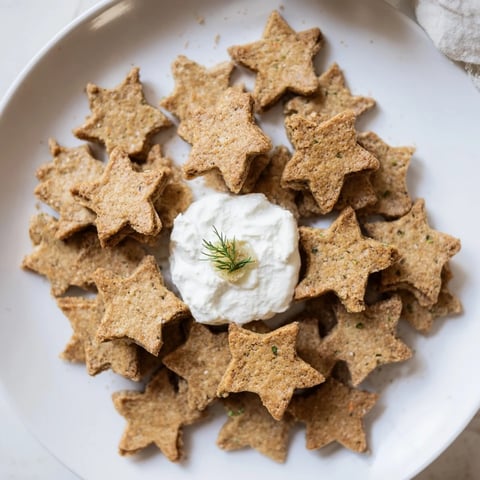 Crisp star-shaped holiday crackers with a creamy dip, perfect for festive appetizer enjoyment.