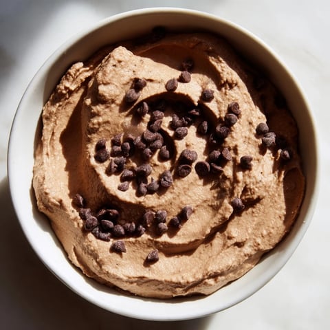 Creamy chocolate hummus served with fresh strawberries, a delightful vegan dessert dip.