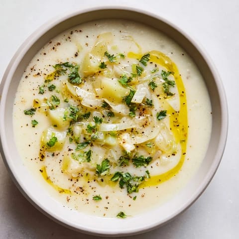 Enjoy a steaming bowl of Creamy Garlic Potato Soup, the perfect easy weeknight dinner with crusty bread.