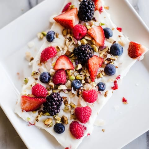 Refreshing Berry Yogurt Bark, speckled with granola and berries, ready to serve and enjoy.
