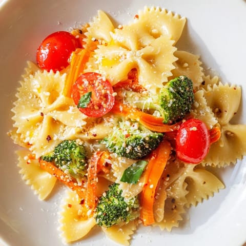 Bow-tie pasta primavera with fresh vegetables in a garlic olive oil sauce and herbs.