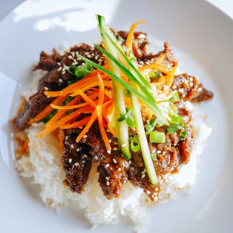 A delicious Bulgogi beef bowl, brimming with marinated beef and colorful, crisp garnishes.